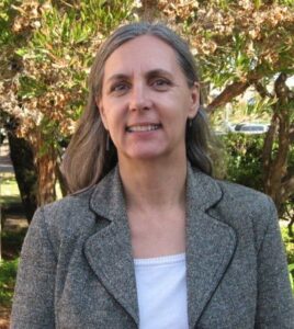 Marie Doerner photo - standing in a sunny location with trees in the background